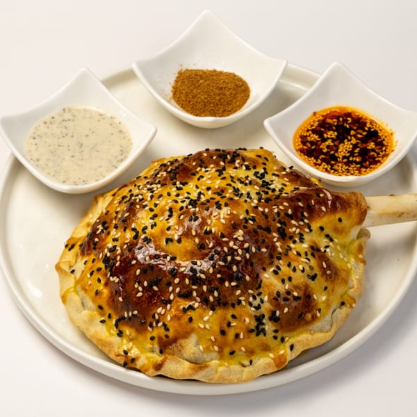 Kusan Collective's lamb shank in pastry with sesame seeds, served with three dipping sauces.